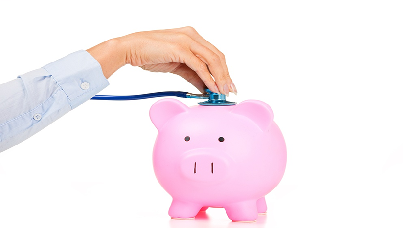 Woman's hand with stethescope on piggy bank.png